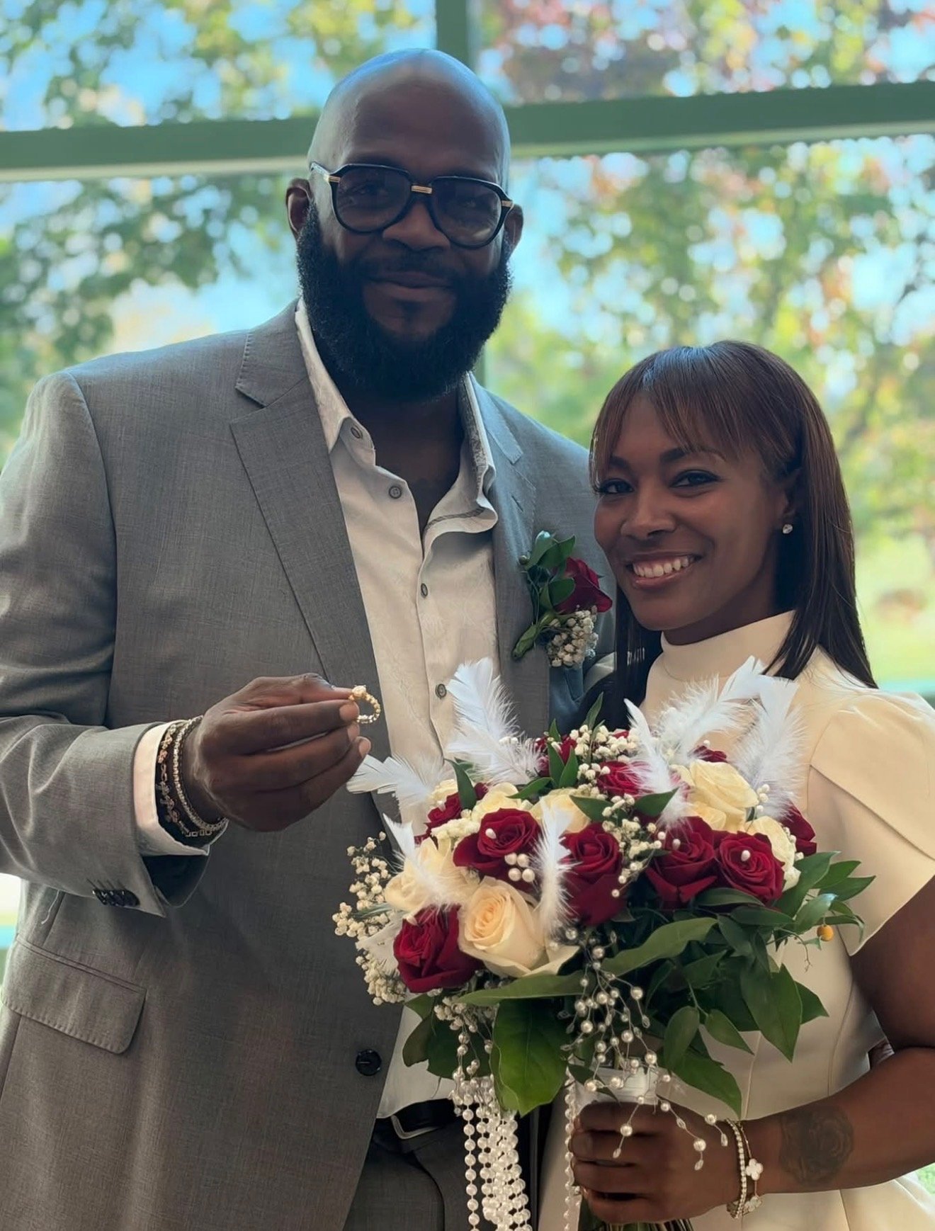 A wedding couple holding their Blossoms & Gems bouquet